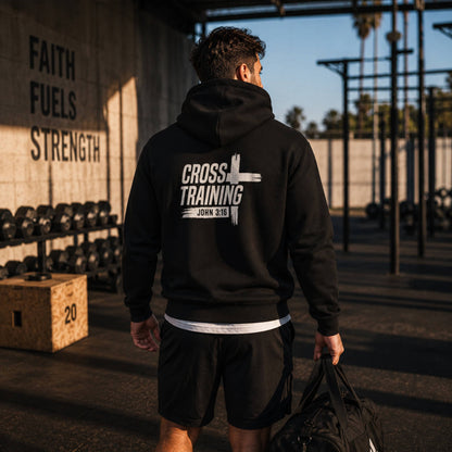 Back view of a man wearing The Avielle Cross Training John 3:16 black zip hoodie at an outdoor gym after training.